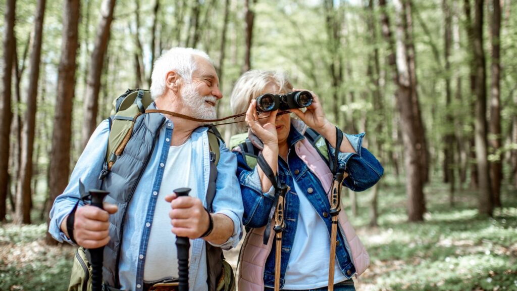 a couple are on a hike while birdwatching