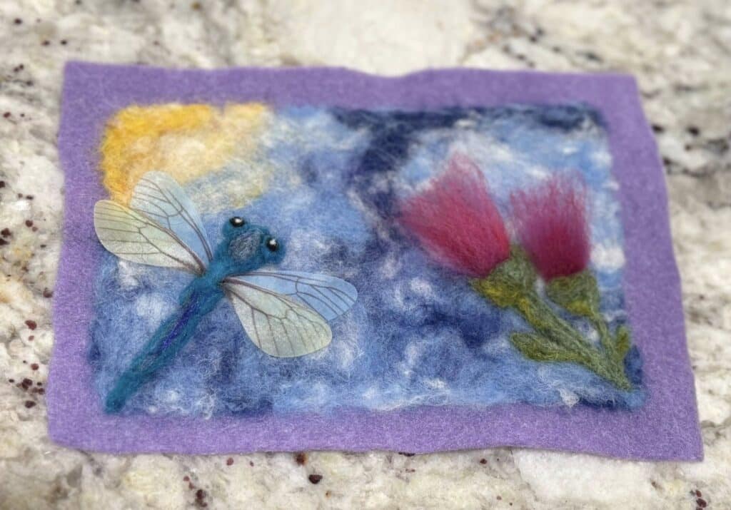 Felting image of dragonfly and flowers